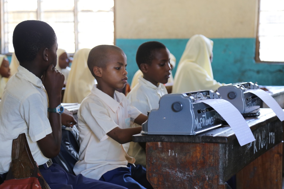 In the front row, two blind students use Braille machines during class. Kisiwandui primary school in Zanzibar, Tanzania.