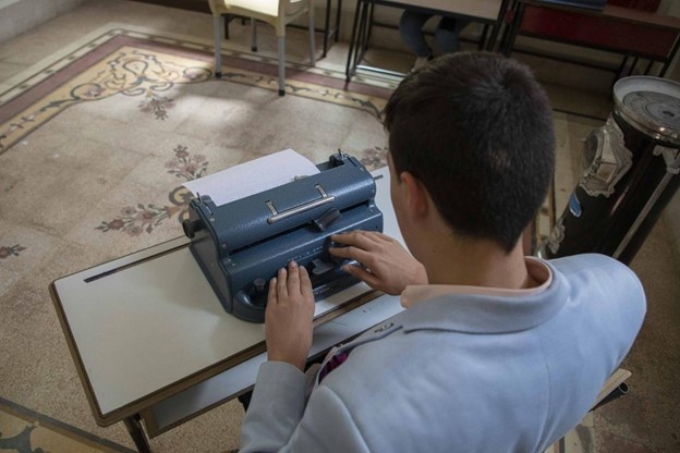 Ameer uses a Braille typewriter in Homs city, central Syria.  