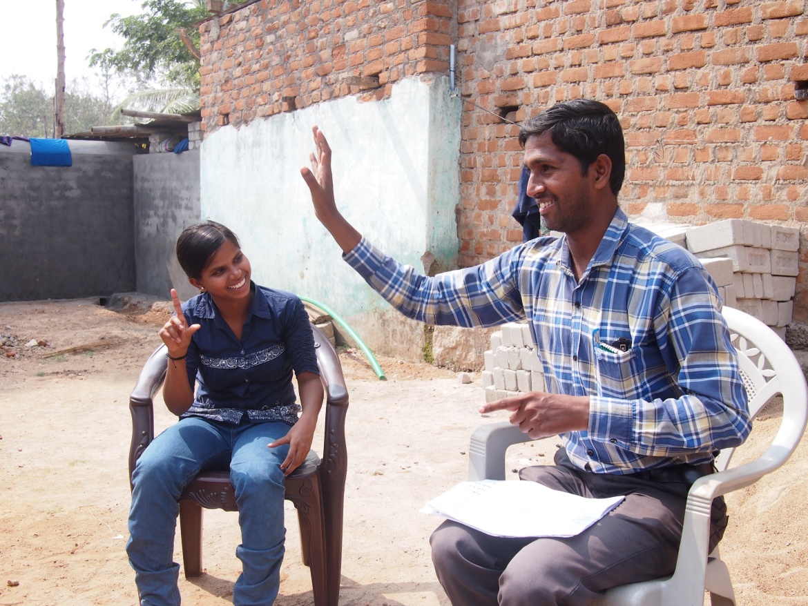 Pradeep Sabat, a deaf role model in India, working with a teenager to develop her sign language skills. Credit: Deaf Child Worldwide