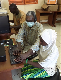 Christophe Oulé from the Blind Association UN-ABPAM Burkina Faso trains a student in accessible technology on the computer.